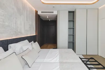 a bedroom with a white bed with white pillows at Luminoso Boutique Hotel in Budva