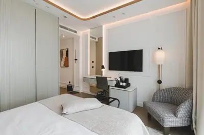 a bedroom with a bed and a desk and a chair at Luminoso Boutique Hotel in Budva