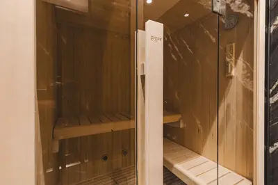 a walk in shower with a glass door at Luminoso Boutique Hotel in Budva
