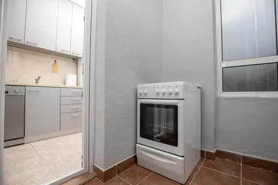 a kitchen with a white oven in a room at Apartment Sole in Cetinje