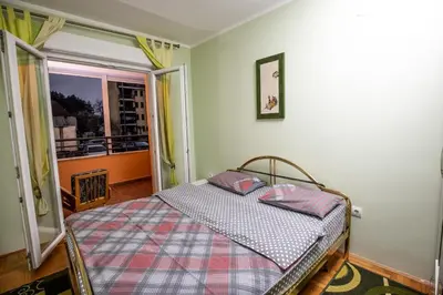 a bedroom with a bed with two pillows on it at Apartment Sole in Cetinje