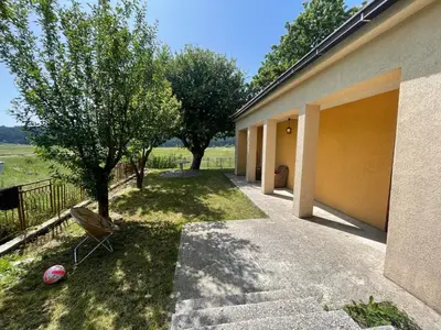a house with a yard with a tree and a fence at The Viewpoint House - Njeguši in Njeguši