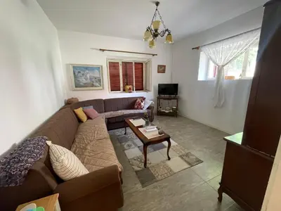 a living room with a couch and a table at The Viewpoint House - Njeguši in Njeguši