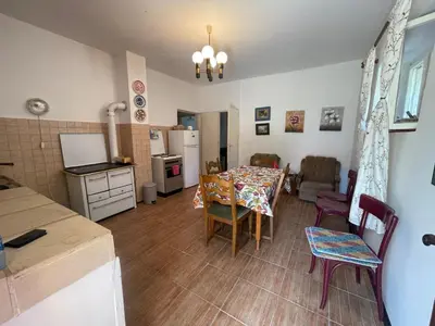 a kitchen and living room with a table and chairs at The Viewpoint House - Njeguši in Njeguši