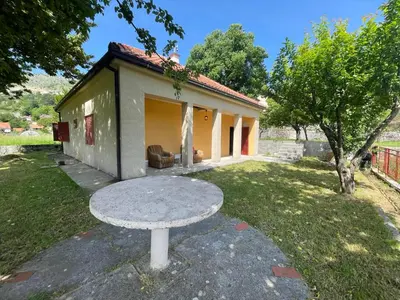 a picnic table in front of a small house at The Viewpoint House - Njeguši in Njeguši