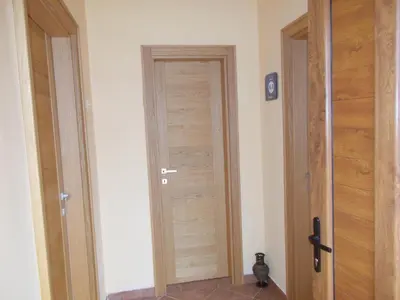 a hallway with a wooden door in a room at Guesthouse Feel Lake in Virpazar