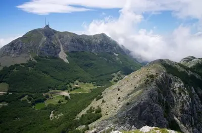 a mountain with a cross on top of it at Apartman Martinović in Cetinje