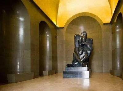 a statue of a woman sitting on a platform in a building at Apartman Martinović in Cetinje