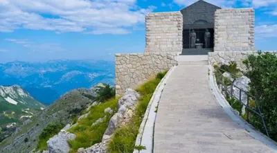 a stone walkway leading to a building on a mountain at Apartman Martinović in Cetinje