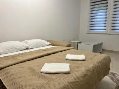 a bedroom with a bed with two towels on it at Apartment Zeneli in Ulcinj