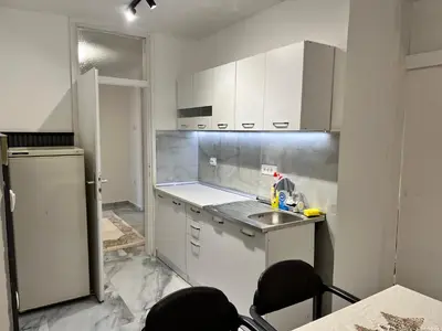 a kitchen with white cabinets and a sink at Apartment Zeneli in Ulcinj
