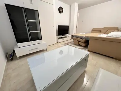 a living room with a large tv and a couch at Apartment Zeneli in Ulcinj