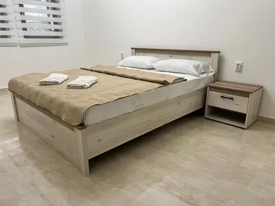 a large bed with two towels on top of it at Apartment Zeneli in Ulcinj