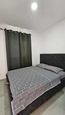 a bedroom with a large bed with green curtains at ValMar in Bar, Susanj