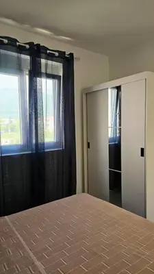 a bedroom with a bed and a window and a mirror at ValMar in Bar, Susanj