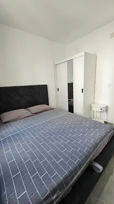 a bedroom with a large bed with a blue comforter at ValMar in Bar, Susanj