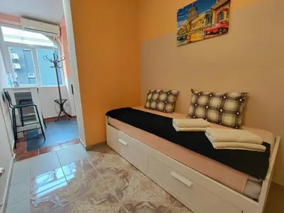 a bedroom with a bed with pillows on it at Black Cat Apartment in Budva