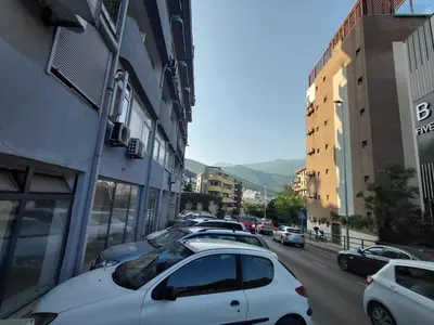 a group of cars parked on a city street at Black Cat Apartment in Budva