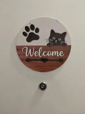 a sign that says welcome with a black cat on it at Black Cat Apartment in Budva
