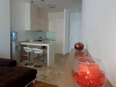 a kitchen and living room with a table with a candle at Apartment TC Lux VLSB in Budva