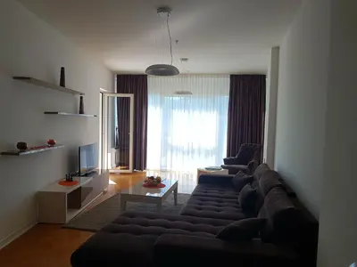 a living room with a couch and two chairs at Apartment TC Lux VLSB in Budva