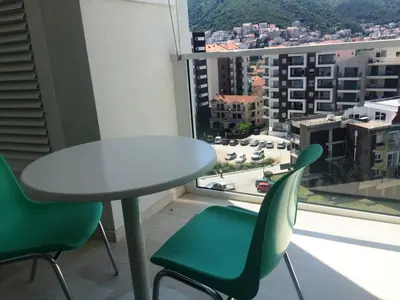 a table and chairs in a room with a window at Apartment TC Lux VLSB in Budva