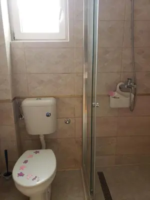 a bathroom with a toilet and a shower at Уютная 1-комнатная квартира с видом на море! in Bar