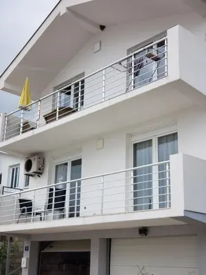 a white apartment building with a balcony at Уютная 1-комнатная квартира с видом на море! in Bar