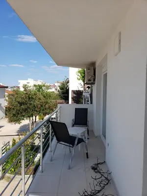 a balcony with two chairs and a table at Уютная 1-комнатная квартира с видом на море! in Bar