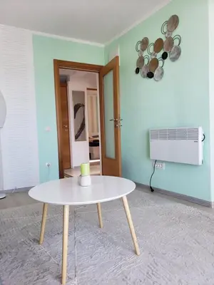 a living room with a table and a fan at Уютная 1-комнатная квартира с видом на море! in Bar