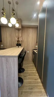 a kitchen with a counter and a table with chairs at Studio 7-Budva in Budva