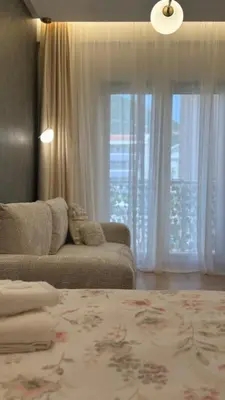 a living room with a couch and a window at Studio 7-Budva in Budva