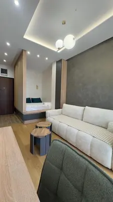 a living room with a couch and a bed at Studio 7-Budva in Budva