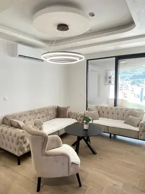 a living room with a couch and a table and chairs at Green Stone lamela B in Rafailovici