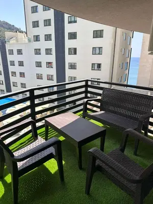 a balcony with two benches and a table and chairs at Green Stone lamela B in Rafailovici