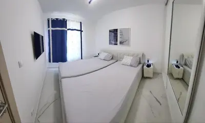 a white bedroom with a large bed in a room at Green Stone lamela B in Rafailovici