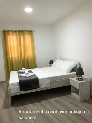 a bedroom with a bed and a yellow curtain at Open Sky Montenegro in Utjeha