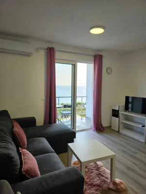 a living room with a couch and a table at Open Sky Montenegro in Utjeha