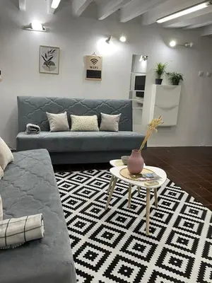 a living room with a couch and a table at Tip top downtown in Podgorica