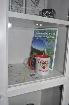 a white drawer with a cup and a magazine at Tip top downtown in Podgorica