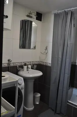 a bathroom with a sink and a shower curtain at Tip top downtown in Podgorica