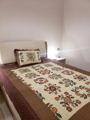 a bed with a pillow on top of it at Первая аренда уютного дома для летнего отдыха in Kravlja
