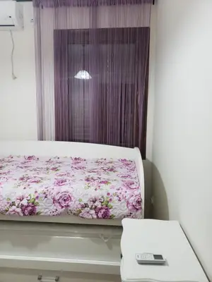 a bed in a room with a window at Первая аренда уютного дома для летнего отдыха in Kravlja