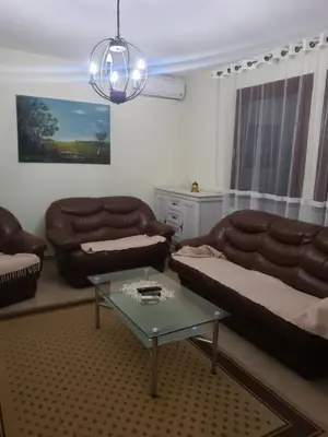 a living room with a couch and a table at Первая аренда уютного дома для летнего отдыха in Kravlja