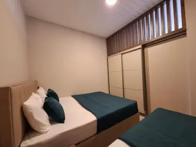 a small bedroom with two beds and a window at Tamape apartment in Katun