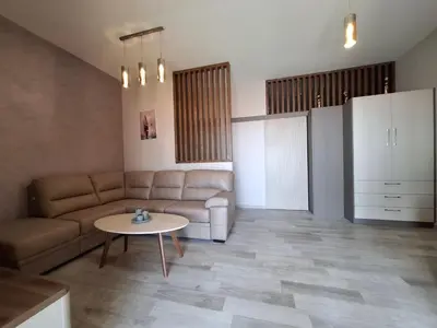a living room with a couch and a table at Tamape apartment in Katun