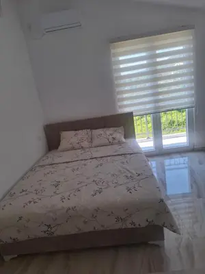 a bedroom with a bed and a window at Apartman Andjela 3 in Lastva