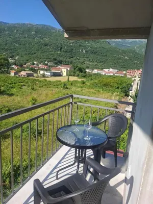 a table and chairs on a balcony with a view at Apartman Andjela 3 in Lastva