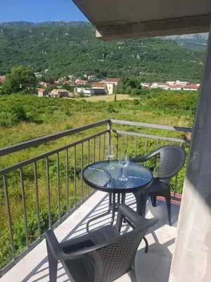 a table and chairs on a balcony with a view at Apartman Andjela 3 in Lastva