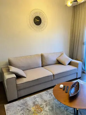 a living room with a couch and a table at Montenegro Prestige Suite in Podgorica